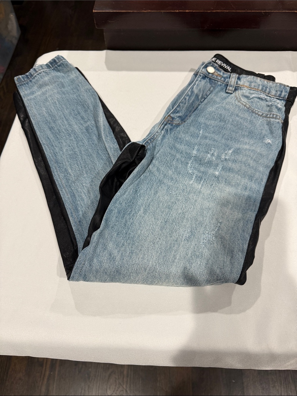 Blue revival jeans. Faux leather in the back.